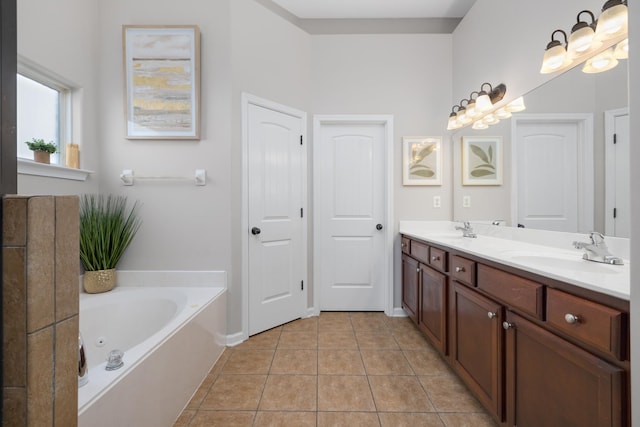 bathroom featuring tile patterned flooring, a bath, and vanity