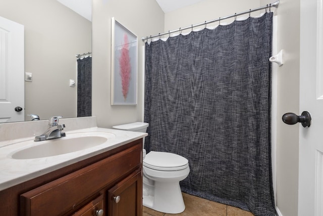 bathroom with tile patterned flooring, vanity, and toilet