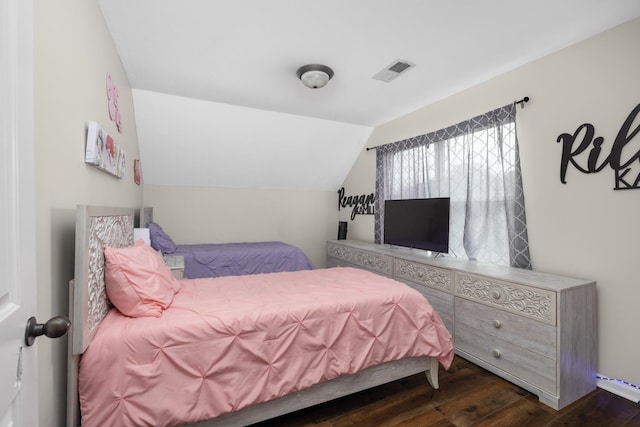 bedroom with vaulted ceiling and dark hardwood / wood-style floors