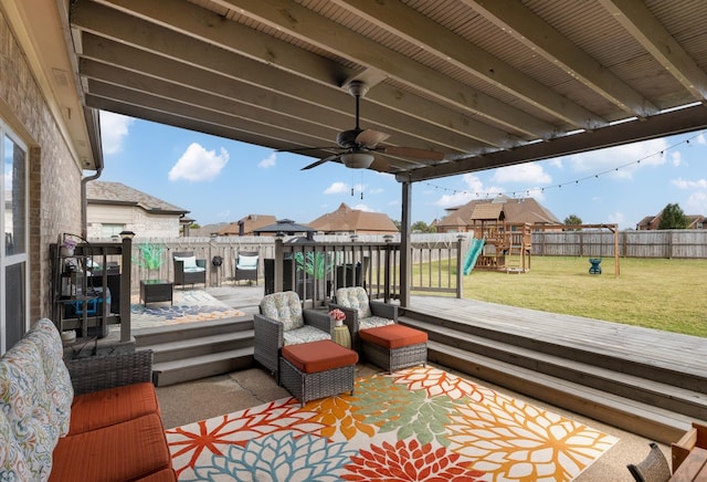 deck with a lawn, a patio area, and a playground