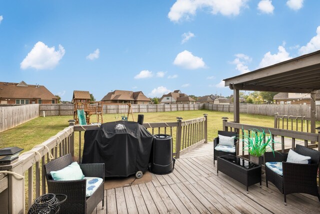 deck featuring a lawn, area for grilling, and a playground