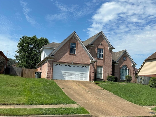 front of property with a front yard and a garage