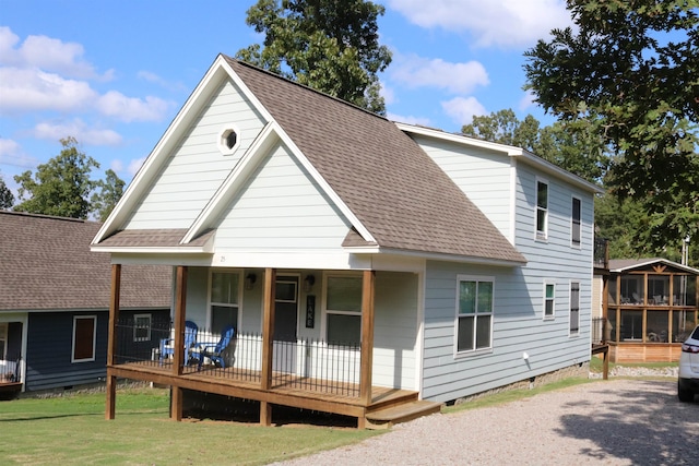 back of house with a lawn and a porch