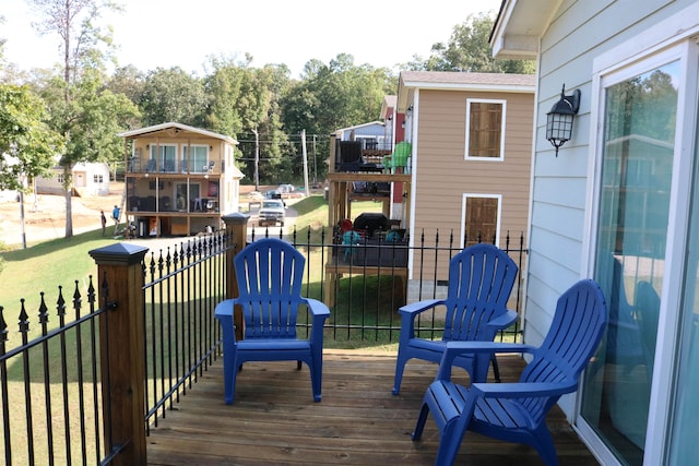 wooden terrace with a lawn