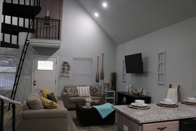 living room with high vaulted ceiling