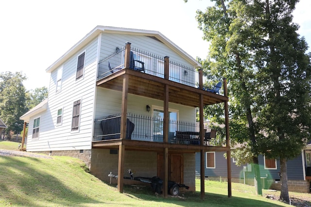 rear view of property featuring a yard and a deck