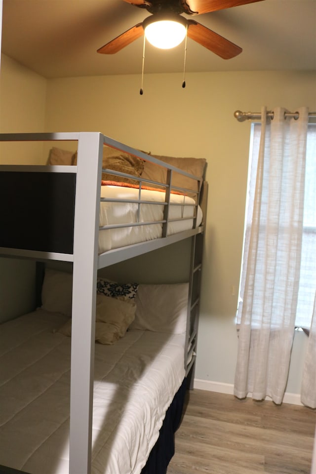 bedroom featuring hardwood / wood-style flooring and ceiling fan