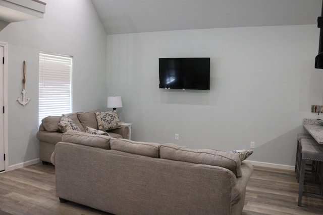 living room with lofted ceiling and hardwood / wood-style flooring