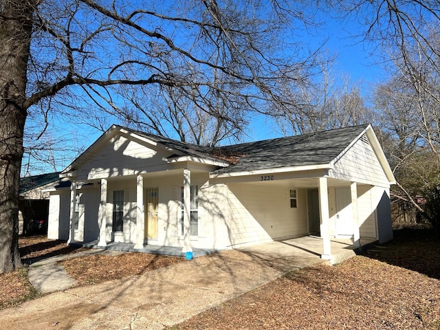 view of side of property featuring covered porch