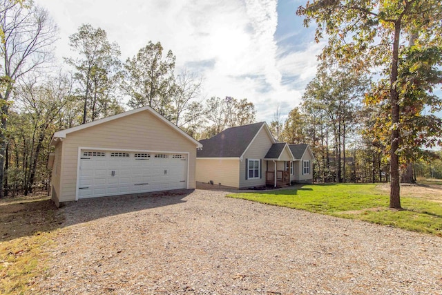 single story home with a garage and a front lawn