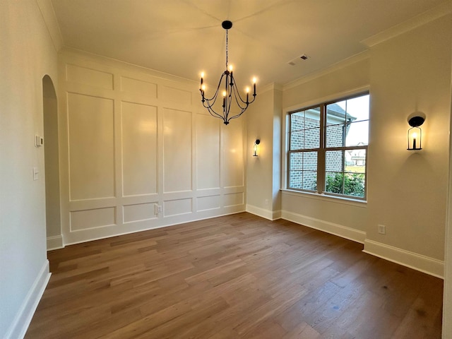 unfurnished dining area featuring a notable chandelier, dark hardwood / wood-style flooring, and crown molding