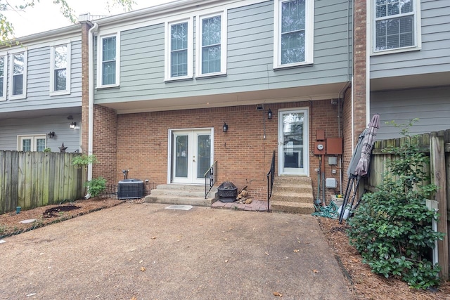 rear view of house with french doors and central air condition unit