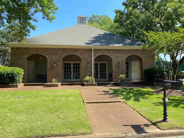 view of front of home with a front lawn, central air condition unit, and french doors