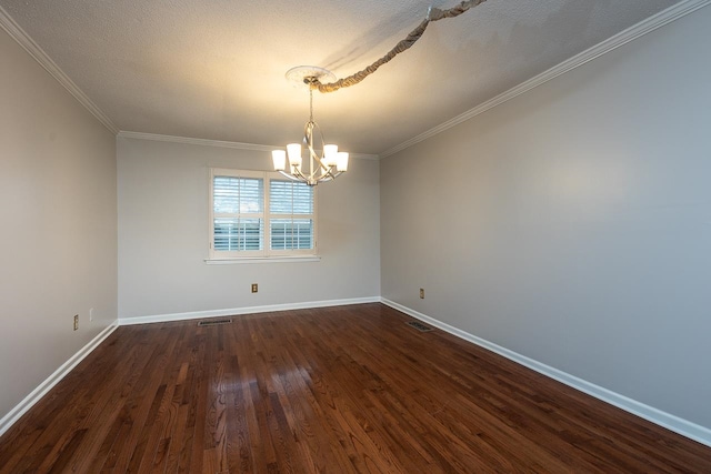 spare room featuring a textured ceiling, crown molding, dark wood-type flooring, and a notable chandelier