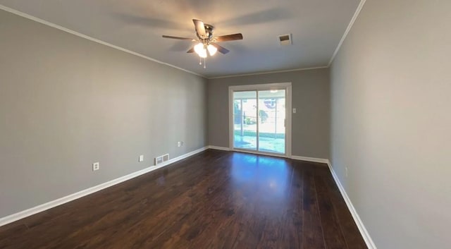 unfurnished room with a ceiling fan, visible vents, baseboards, dark wood finished floors, and crown molding