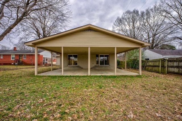 back of property featuring a yard, a patio area, and fence