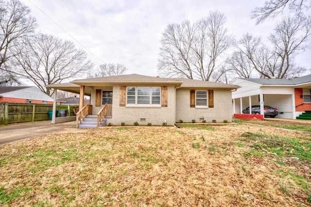 view of front of home featuring a carport, brick siding, crawl space, and concrete driveway