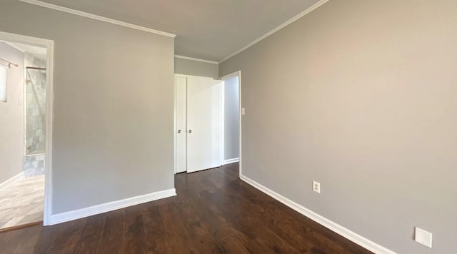 unfurnished bedroom with ornamental molding, dark wood-style flooring, and baseboards