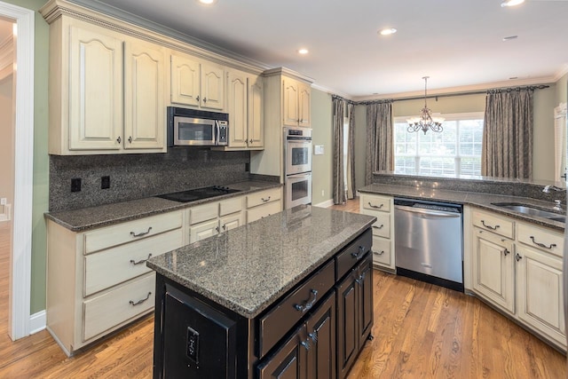 kitchen featuring light hardwood / wood-style floors, sink, appliances with stainless steel finishes, ornamental molding, and decorative backsplash