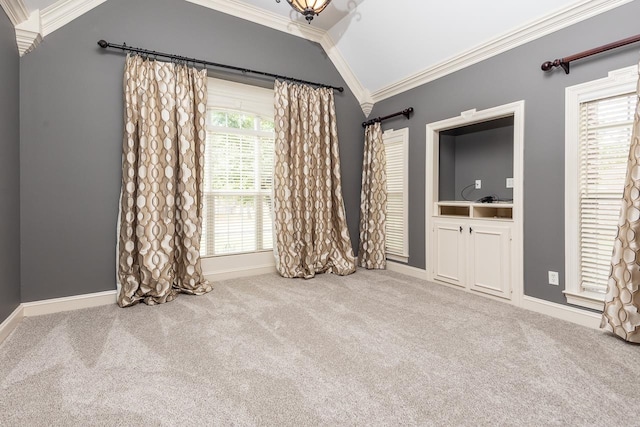 unfurnished bedroom featuring lofted ceiling, carpet flooring, and crown molding