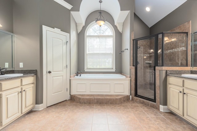 bathroom featuring shower with separate bathtub, lofted ceiling, tile patterned floors, and vanity