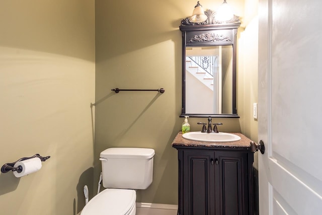 bathroom featuring toilet and vanity