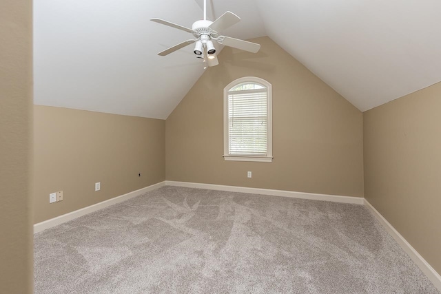 additional living space featuring light colored carpet, ceiling fan, and vaulted ceiling