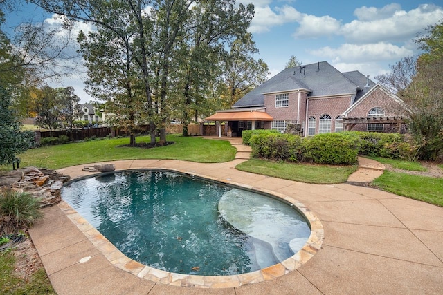 view of pool with a patio and a yard