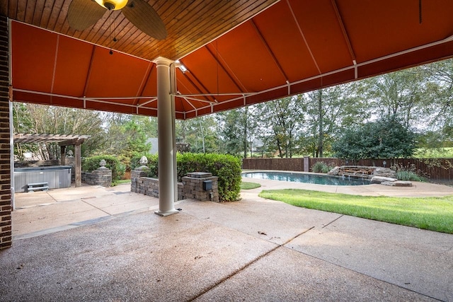 view of patio featuring a swimming pool with hot tub and ceiling fan