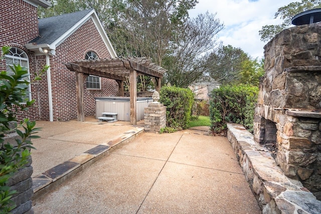 view of patio with a hot tub and a pergola