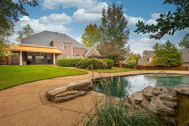 view of swimming pool featuring a patio, a lawn, and pool water feature