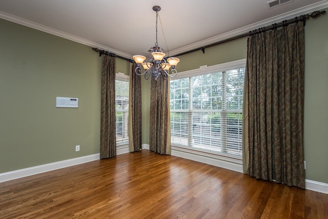 unfurnished dining area with a chandelier, dark hardwood / wood-style floors, and crown molding