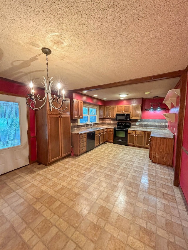 kitchen featuring black appliances, tasteful backsplash, a textured ceiling, pendant lighting, and a chandelier