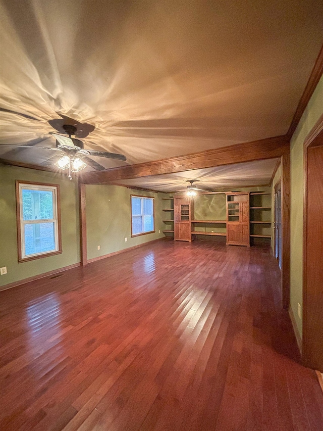 unfurnished living room with hardwood / wood-style floors, ceiling fan, beamed ceiling, and built in features