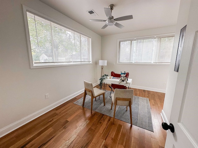 home office featuring wood-type flooring and ceiling fan