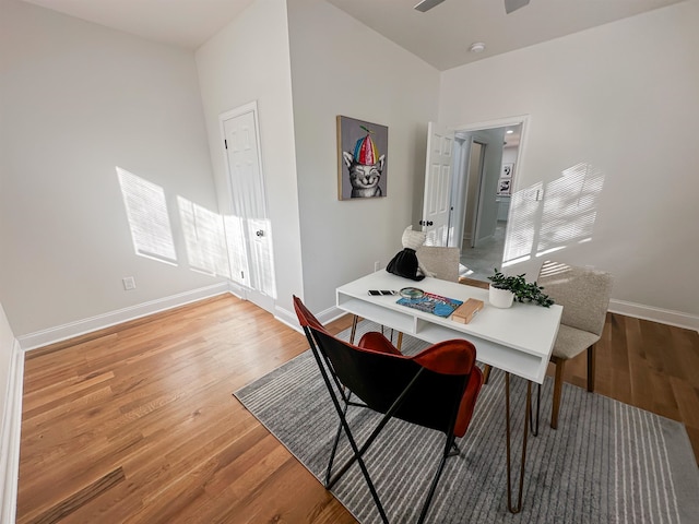 dining area with hardwood / wood-style flooring and ceiling fan