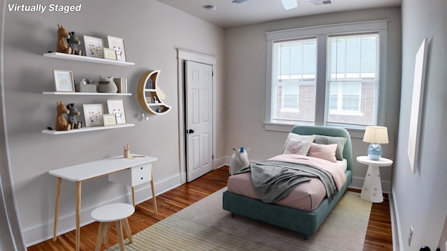 bedroom with dark hardwood / wood-style floors