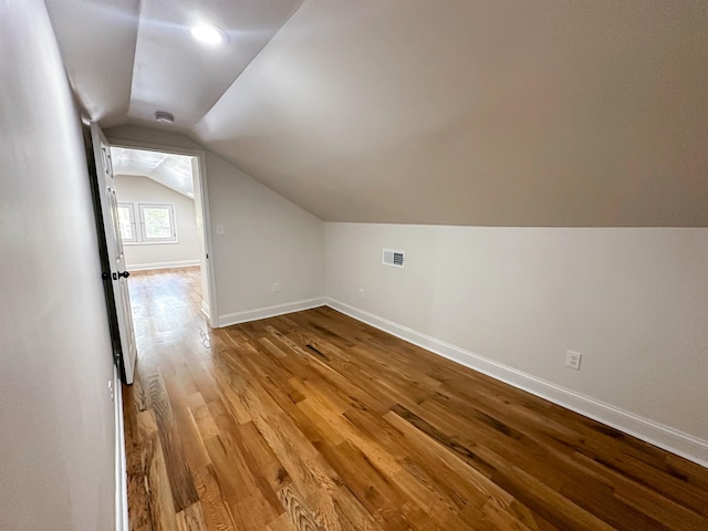 bonus room with hardwood / wood-style flooring and lofted ceiling