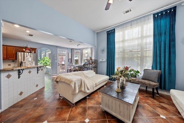 living room featuring dark tile patterned floors and ceiling fan