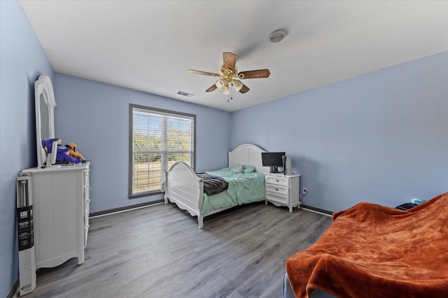 bedroom with hardwood / wood-style flooring and ceiling fan