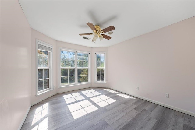 unfurnished room featuring light wood-type flooring and ceiling fan