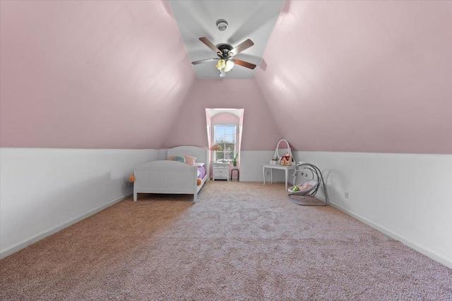 unfurnished bedroom featuring ceiling fan, vaulted ceiling, and carpet