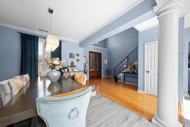 dining room featuring wood-type flooring, french doors, and crown molding