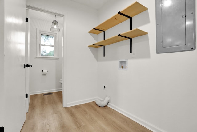 laundry room featuring electric panel, light hardwood / wood-style floors, hookup for a washing machine, and electric dryer hookup