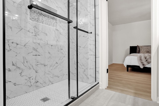 bathroom with walk in shower and wood-type flooring