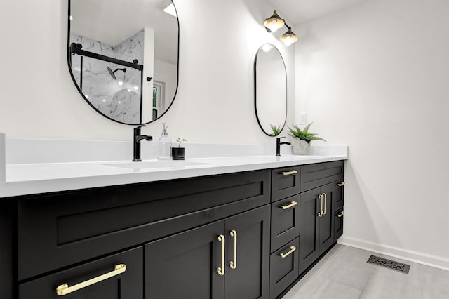 bathroom with vanity, an enclosed shower, and tile patterned floors