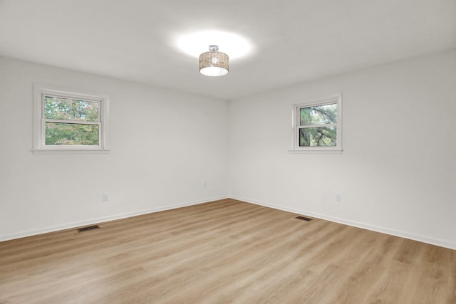 unfurnished room featuring light hardwood / wood-style floors and a healthy amount of sunlight