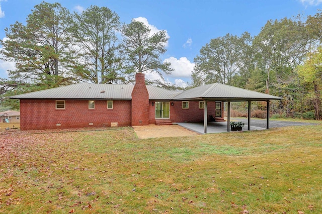 rear view of property with a lawn and a patio