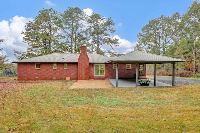 back of property featuring a patio area and a yard