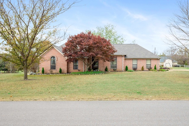 ranch-style house featuring a front lawn